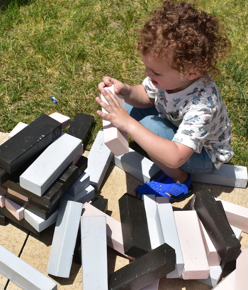 Bellamy Belman, 3, of Dixon, builds a tower of blocks at the RB&W Park, Saturday, June 21, 2025, in Rock Falls. Rock Falls Chamber of Commerce held their annual Summer Splash over the weekend. Sweltering heat shortened some of the day’s plans.