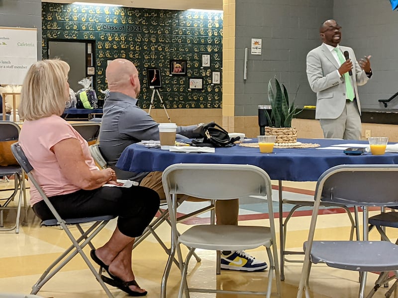 Oswego School District chief financial officer Raphael Obafemi speaks to those attending the second annual CommUNITY in Education Breakfast on June 3 at Traughber Junior High School.