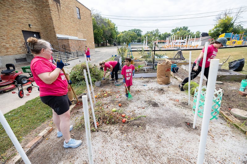 Between explorations of interesting bugs and insects, Kam Horton, 7, of Dixon helps clear up the garden Saturday, Sept. 13, 2025, during United Way of Lee County’s Day of Caring.