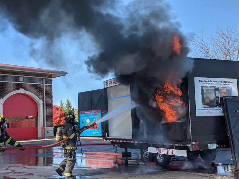 People attending the Oswego Fire and Oswego Police’s annual joint open house on Oct. 26 saw how quickly a fire can spread during a live burn demonstration.
As part of the demonstration, two rooms with smoke alarms were set on fire. One room contains a single fire sprinkler, while the adjoining room does not.
Those watching the demonstration saw how rapidly the fire spread in the room without a fire sprinkler. In the room with the fire sprinkler, the fire is suppressed quickly.
