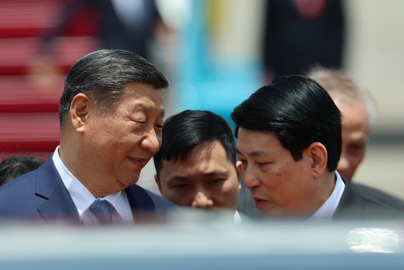 Chinese President Xi Jinping, left, speaks with Vietnam's President Luong Cuong on his arrival at the Noi Bai International Airport in Hanoi, Vietnam Monday, April 14, 2025. (Athit Perawongmetha/Pool Photo via AP)
