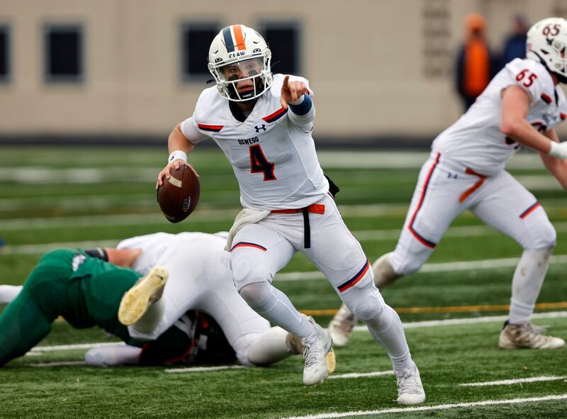 Oswego's Drew Kleinhans (4) directs traffic during the varsity football second-round 8A playoff game between Oswego and Lane Tech on Saturday, Nov. 8, 2025 in Chicago.