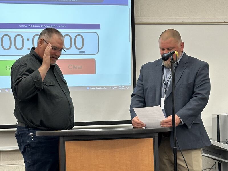 Newly elected Kaneland D302 School Board Member Scott Stalcup (left) is sworn in by Superintendent Kurt Rohlwing during an April 28, 2025, School Board meeting.