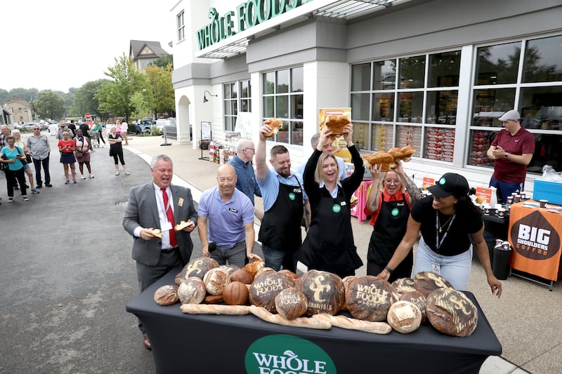 Whole Foods representatives and St. Charles Mayor Clint Hull (far left) break bread on Wednesday, June 25, 2025 to officially open the new Whole Foods Market in St. Charles.
