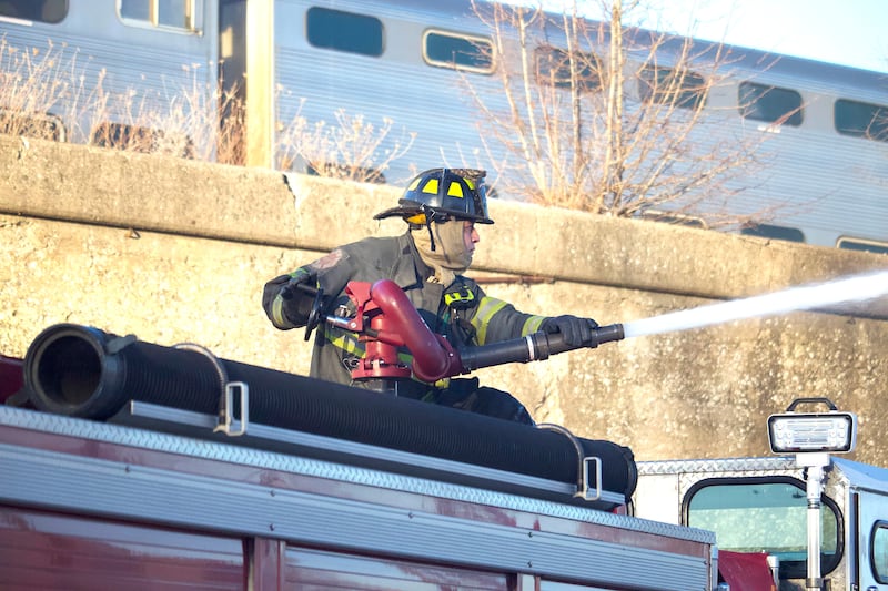 Joliet firefighters at the scene of a fire at an old commercial building on Thursday, Jan. 29, 2026, at the corner of South Eastern Avenue and Washington Street in Joliet.