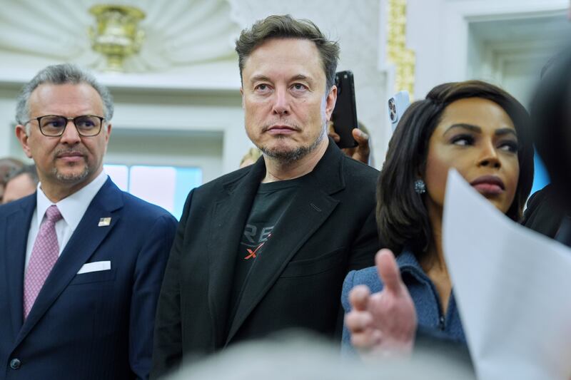 Elon Musk looks on as President Donald Trump meets South African President Cyril Ramaphosa in the Oval Office of the White House, Wednesday, May 21, 2025, in Washington. (AP Photo/Evan Vucci)