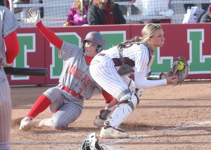 L-P's Callie Mertes slides in safely to home as the throw comes in late to Morris catcher Addy Hackett  on Monday, April 7, 2025 at the L-P Athletic Complex in La Salle.