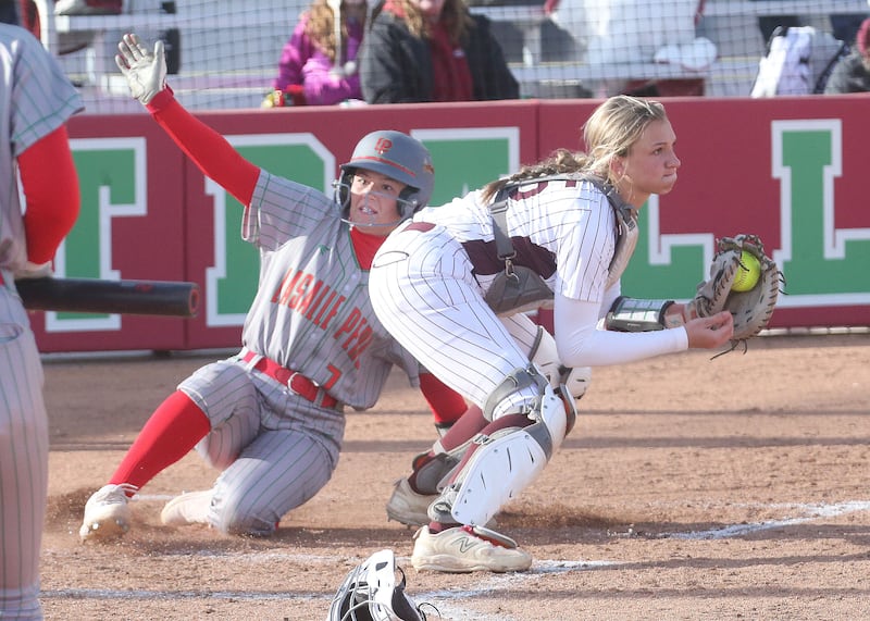 L-P's Callie Mertes slides in safely to home as the throw comes in late to Morris catcher Addy Hackett on Monday, April 7, 2025 at the L-P Athletic Complex in La Salle.