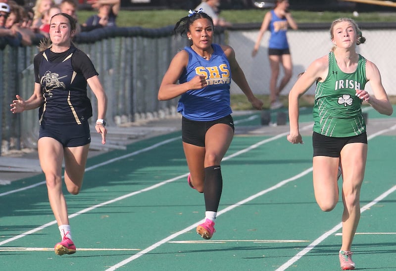 (From left) Marquette's Madisyn Trainor, Somonauk's Alexis punsalan and Seneca's Lila Coleman compete in the 100 meter dash during the Class 1A Sectional track meet on Thursday, May 15, 2025 at Seneca High School.