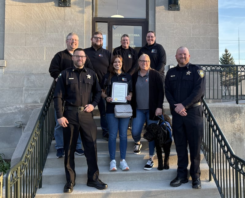 Members of Ottawa Central Dispatch and Ottawa Police Department pose for a photo outside Ottawa City Hall on Tuesday, April 15, 2025, following a ceremony recognizing National Public Safety Telecommunicators Week.