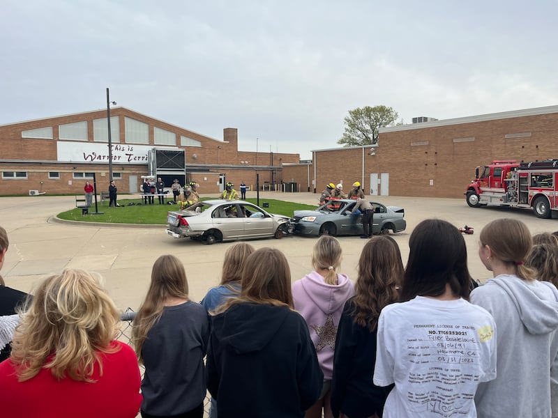 Students watch a mock scenario of first responders reporting to a crash Wednesday, April 30, 2025, during an Operation Prom event at Woodland School in rural Streator.