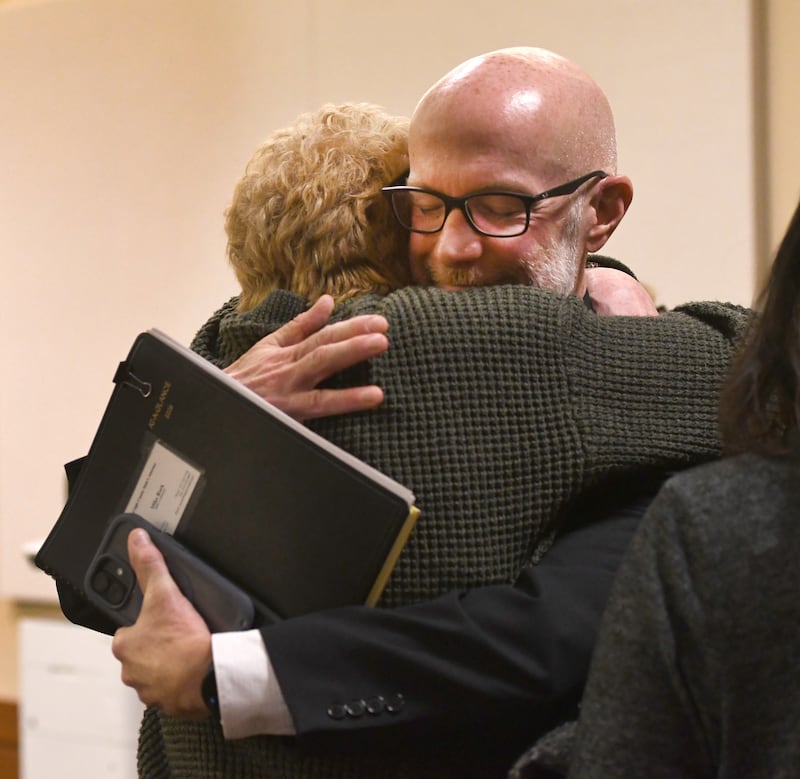 Ogle County State's Attorney Mike Rock hugs Luann Rosko of Mt. Morris on Thursday, Jan. 29, 2026 after jurors found Duane "DC" Meyer guilty of murdering her daughter Maggie, 31, and her grandson Amos, 3, in 2016.
