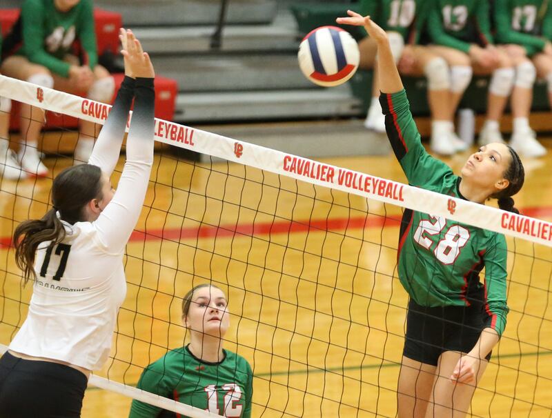 L-P's Ava Currie spikes the ball past Sycamore's Laney Block on Tuesday, Oct. 15, 2024 in AJ Sellett Gymnasium at L-P High School.