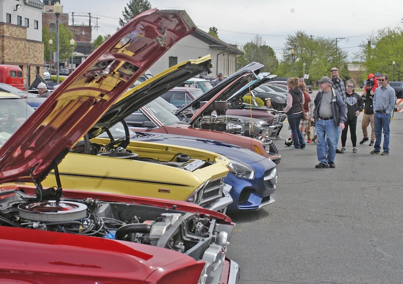 Spectators look over cars at the car show. Sterling Main Street's 12th Annual Car Show took place at the Sterling Marketplace on Sunday, May 4th, 2025.