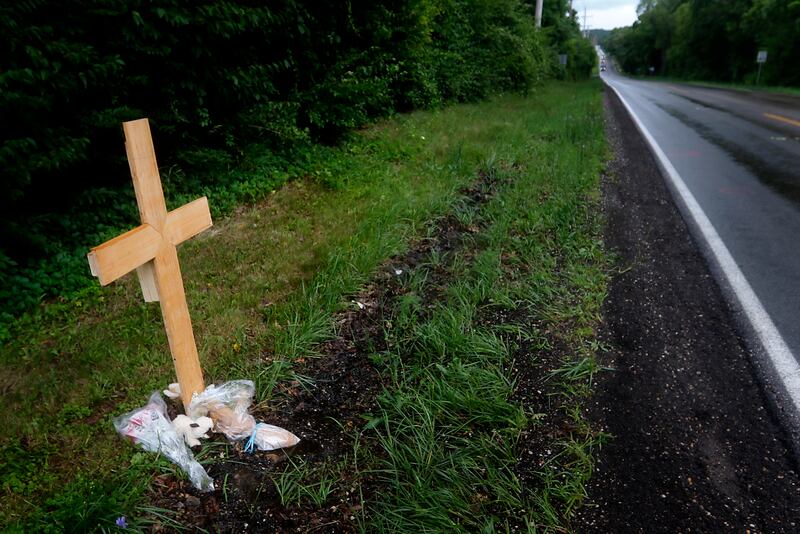 A cross alongside the roadway on July 6, 2025, near Crystal Lake, where a 15-year-old boy was fatally hit by a car the on Wednesday, July 2. Police said the driver fled the scene.
