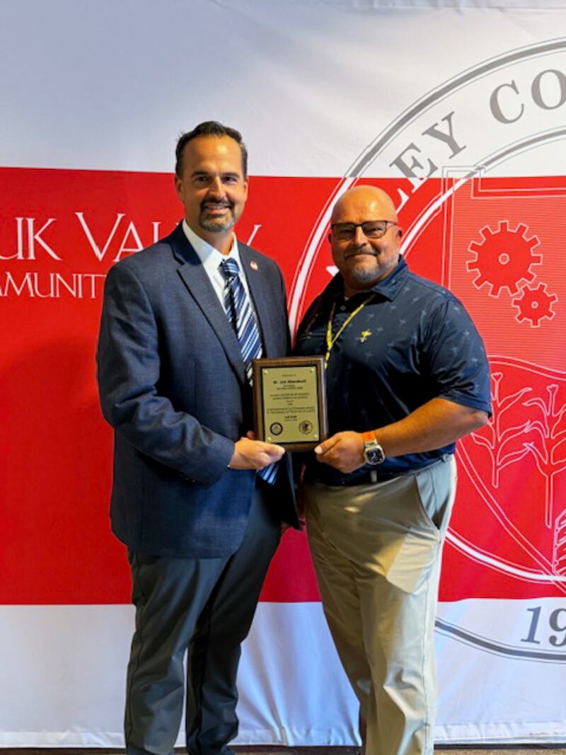 Regional Superintendent of Schools for ROE #47, Christopher Tennyson, presents Dr. Jon Mandrell with the Friends of Education Award.