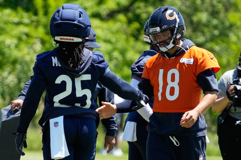 Chicago Bears quarterback Caleb Williams, right, greets running back Kyle Monangai during the NFL football team's practice Thursday, May 28, 2026, in Lake Forest, Ill. (AP Photo/Nam Y. Huh)