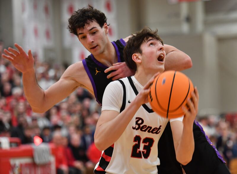 Benet’s Edvardas Stasys (23) goes to the basket as Downers Grove North’s Aidan Akkawi defends during the Class 4A Benet Sectional championship game on March 7, 2025 at Benet Academy in Lisle.