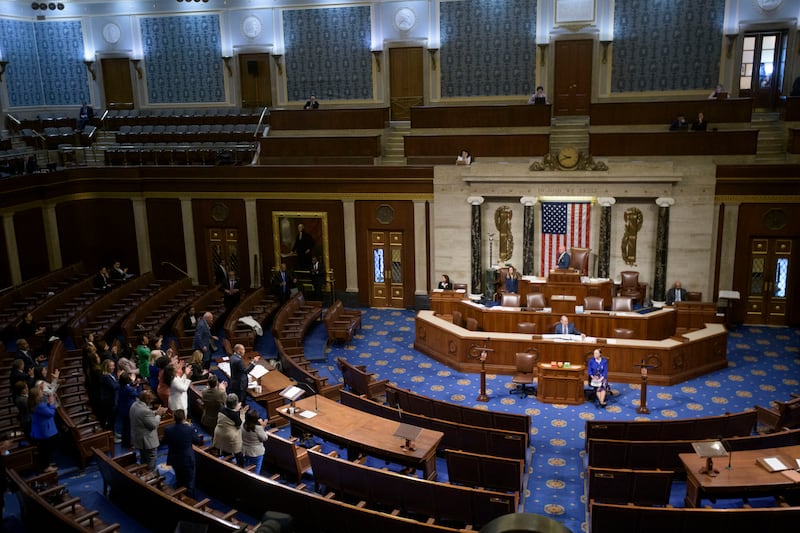 House Minority Leader Hakeem Jeffries, D-N.Y., left, speaks in the House chamber as House Democrats stand to applaud him, prior to the final vote for President Donald Trump's signature bill of tax breaks and spending cuts, at the Capitol, Thursday, July 3, 2025, in Washington.