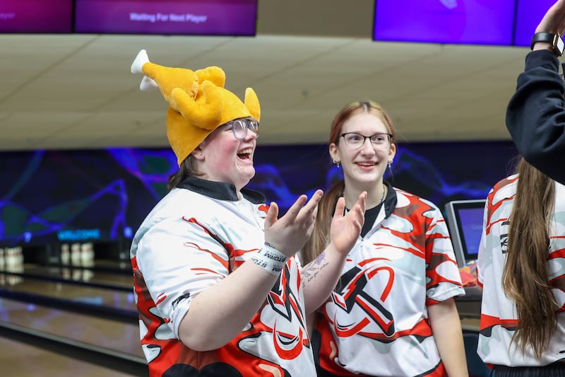 After bowling three strikes for a turkey in her final frame, Bradley-Bourbonnais' Bri Dyer-Riegle wears a turkey hat as her coach and teammates congratulate her during the Boilermakers' victory over Kankakee, Peotone and Bishop McNamara in the All-Area matchup on Wednesday, Feb. 4, 2026.