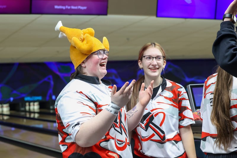 After bowling three strikes for a turkey in her final frame, Bradley-Bourbonnais' Bri Dyer-Riegle wears a turkey hat as her coach and teammates congratulate her during the Boilermakers' victory over Kankakee, Peotone and Bishop McNamara in the All-Area matchup on Wednesday, Feb. 4, 2026.