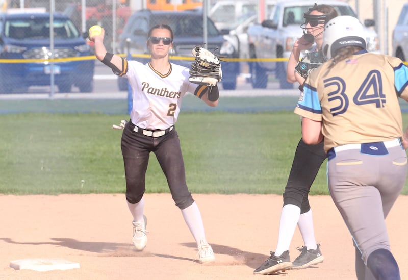 Putnam County shortstop Ella Pyszka (2) throws to first base while Marquette baserunner Lily Brewer (34) heads to second Tuesday, April 29, 2025, in Ottawa.