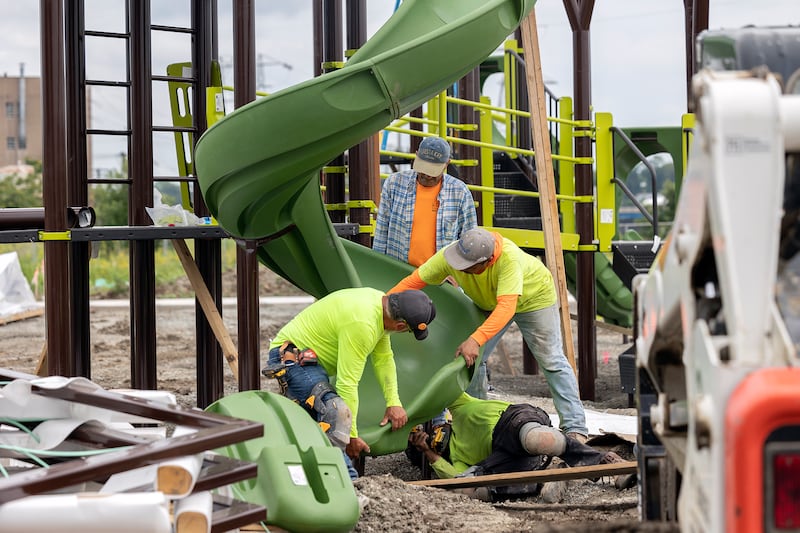Workers get a slide in place Tuesday, July 8, 2025, at Sterling’s riverfront park. Installation of the equipment is hoped to be complete by the end of the week.