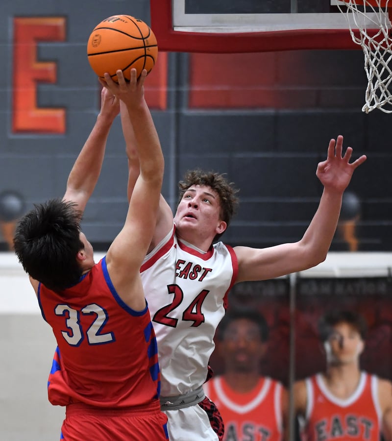 Glenbard East's Sam Walton, right, blocks a shot by Glenbard South's Mason Fort during Friday’s game in Lombard.