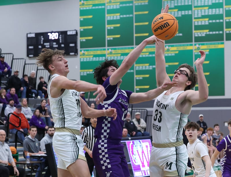 Bishop McNamara's Coen Demack, left, and Callaghan O'Connor, right, knock the ball away from Wilmington's Ryan Kettman during Bishop McNamara's 61-24 victory over Wilmington in the IHSA Class 2A Seneca Sectional semifinal on Tuesday, March 3, 2026.