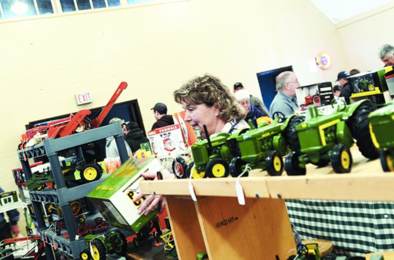Toy vendor Kathy Obermeyer of Valparaiso, Ind., sells an item to a customer at the Sublette's annual antique tractor and toy show in an undated file photo.