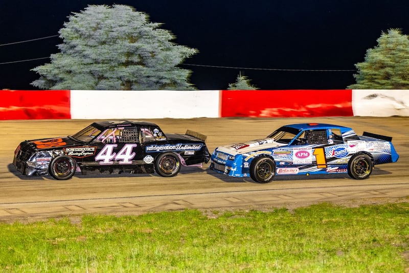 Renee Farren, in the 44 car, and Randy Weeze, in the 1 car, battle during a street stock heat race.