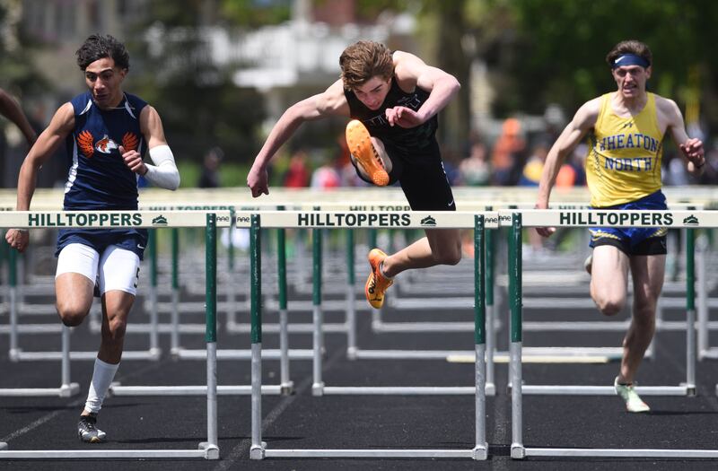 Glenbard West’s Ben Schoettle, middle, wins the 110-meter hurdles during the Glenbard West boys track and field invite on Saturday, May 3, 2025 in Glen Ellyn.