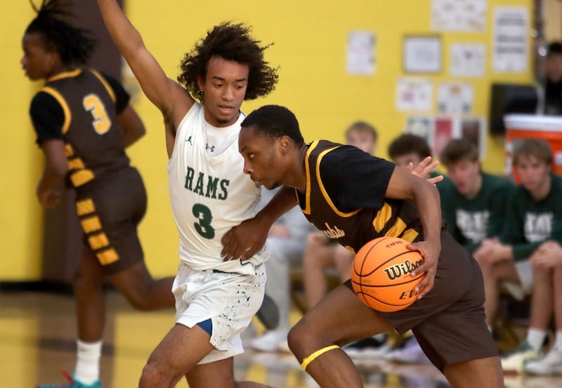 Jacobs’ Elijah Bell, front, drives as Grayslake Central’s Alex Granville defends in varsity boys basketball Hinkle Holiday Classic action on Tuesday, Dec. 23, 2025, at Jacobs High School in Algonquin.