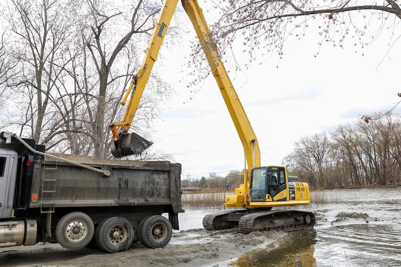 Sediment is removed from the Kankakee River during a kick-off event for the project at the Aroma Park boat ramp on Tuesday, April 15, 2025.