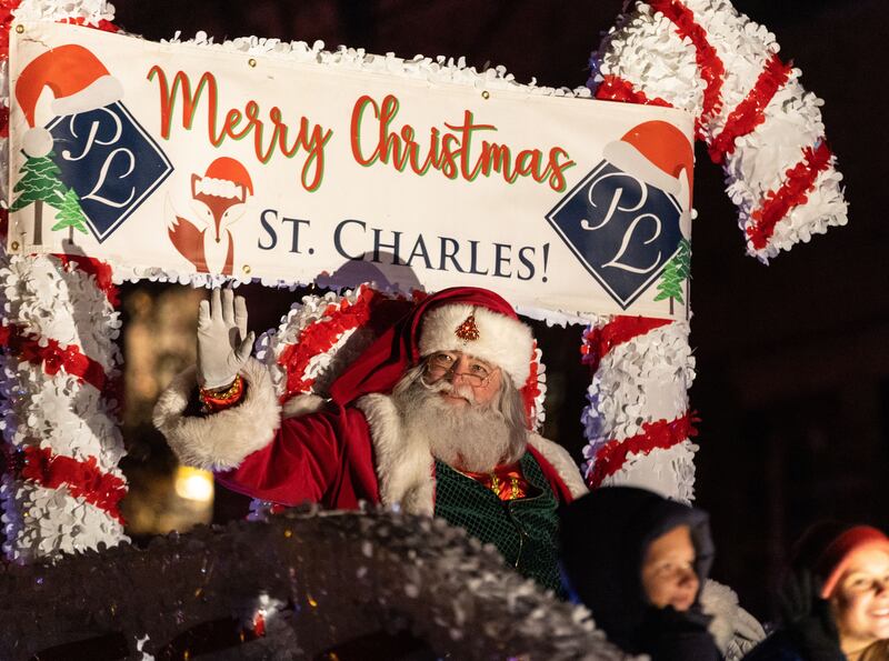 Santa waves to spectators while bringing the Holiday Homecoming Electric Christmas Parade to a close in St. Charles on Saturday, Nov. 30, 2024.