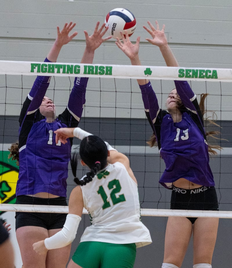Manteno's Emily Horath and Olivia McElroy block an attack from Seneca's Lexie Buis during Class 2A regional final Thursday, Oct. 30, 2025, at Seneca High School.