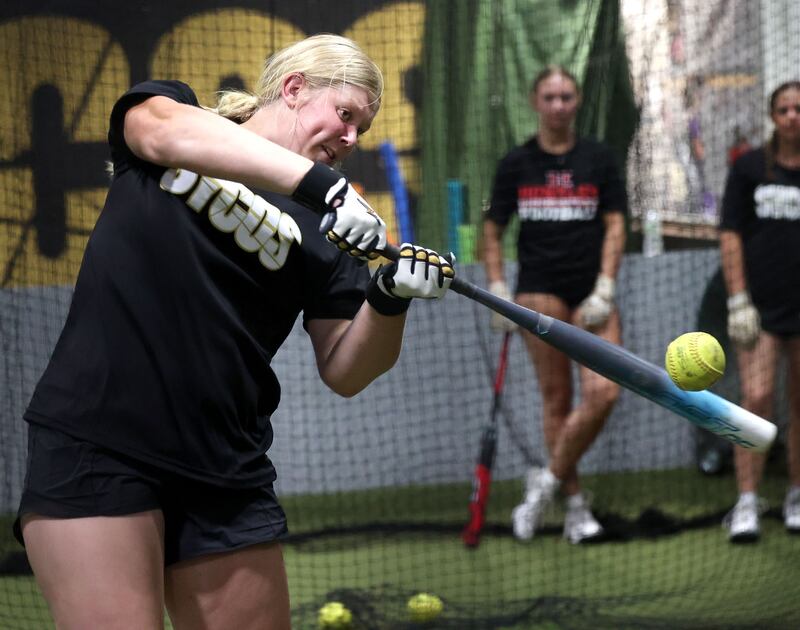 Sycamore Sycos 16u softball player Camryn Knox takes some swings in the batting cage as her teammates wait their turn Wednesday, June 18, 2025, at their indoor practice facility in DeKalb.