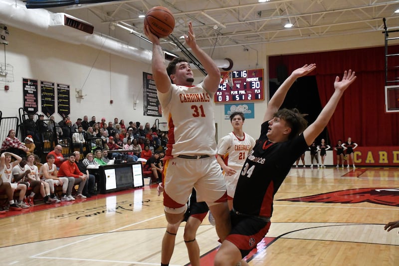 St. Anne's Brandon Schoth shoots a layup while being guarded by Momence's Jackson Ford during St. Anne's 61-46 victory over Momence on Tuesday December 9, 2025.