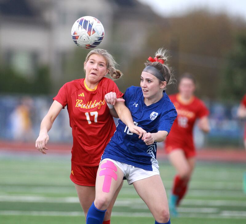 Batavia’s Natalie Warner (left) and Geneva’s Riley Pryor go after the ball during a Tri-Cities Night game at St. Charles North on Tuesday, April 23, 2024.