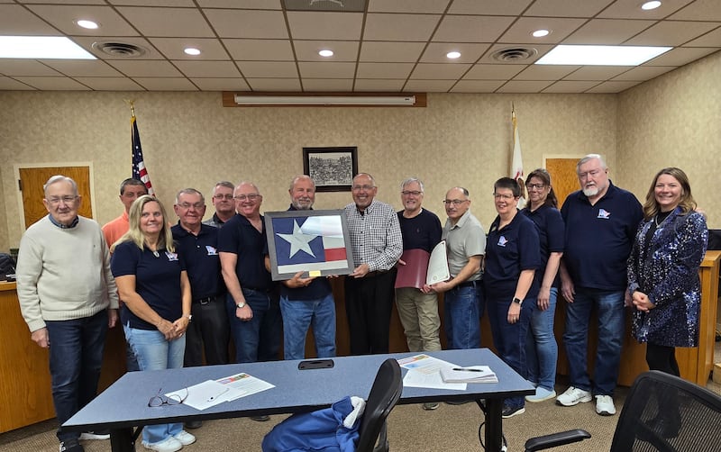 Flags of Freedom Committee members present a star from a former flag Monday, April 7, 2025, to the city of Princeton at the Princeton City Council meeting.