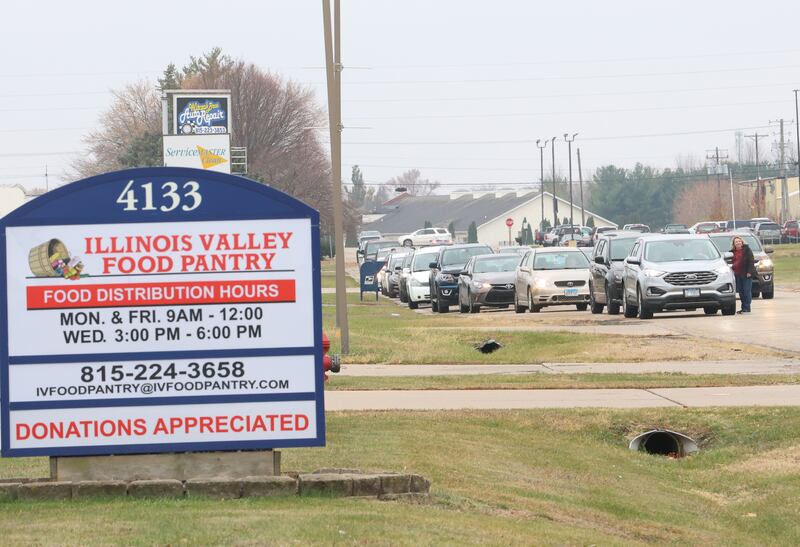 A long line of cars wait for orders on Progress Boulevard during the Thanksgiving Distribution on Wednesday, Nov. 19, 2025 at the Illinois Valley Food Pantry in Peru. Nearly 500 families or roughly 1,200 people in the Illinois Valley got a Thanksgiving meal.