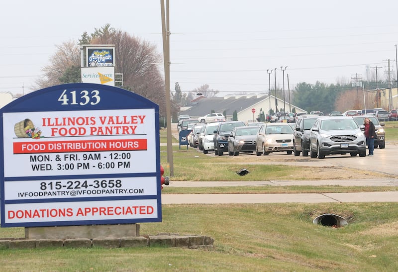 A long line of cars wait for orders on Progress Boulevard during the Thanksgiving Distribution on Wednesday, Nov. 19, 2025 at the Illinois Valley Food Pantry in Peru. Nearly 500 families or roughly 1,200 people in the Illinois Valley got a Thanksgiving meal.