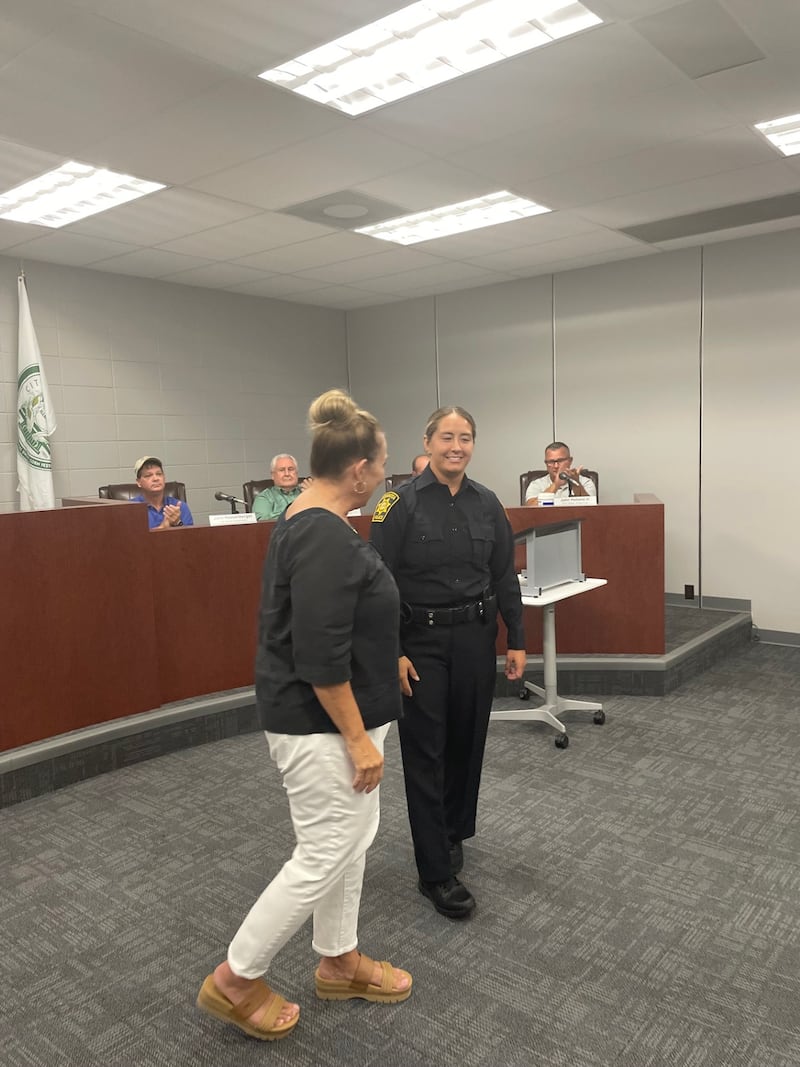 New Mendota Police Officer Sabrina Poole (standing, right) smiles after taking the oath of office Monday, Aug. 18, 2025, from Paula Daley (standing, left) of the Mendota Fire and Police Commission. Poole's hiring makes the Mendota Police Department fully staffed.