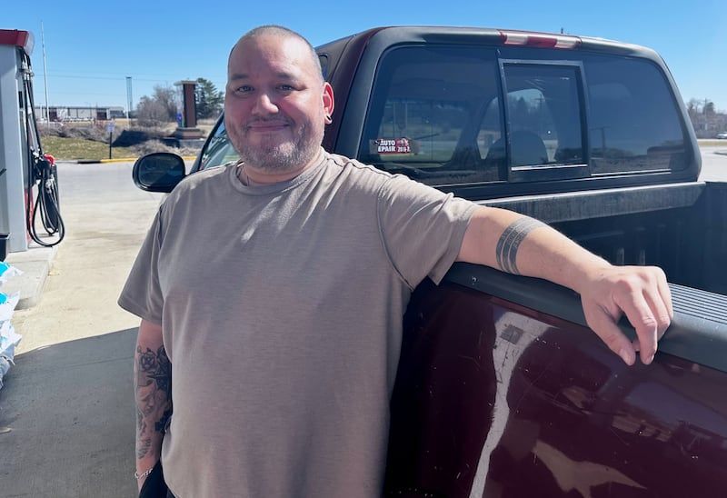 Francisco Castillo stands next to his son's Ford F-150 after filling up, Monday, March 9, 2026, at a gas station in De Soto, Iowa. (AP Photo/Hannah Fingerhut)