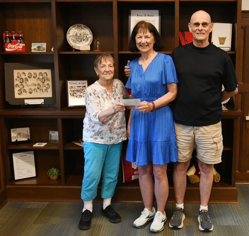 Cheri DePaepe (left), L-P Foundation Board President, receives a donation of $161,000 in memory of Linda Mae Hiltabrand from her sister and brother-in-law, Marie and Chuck Taylor.