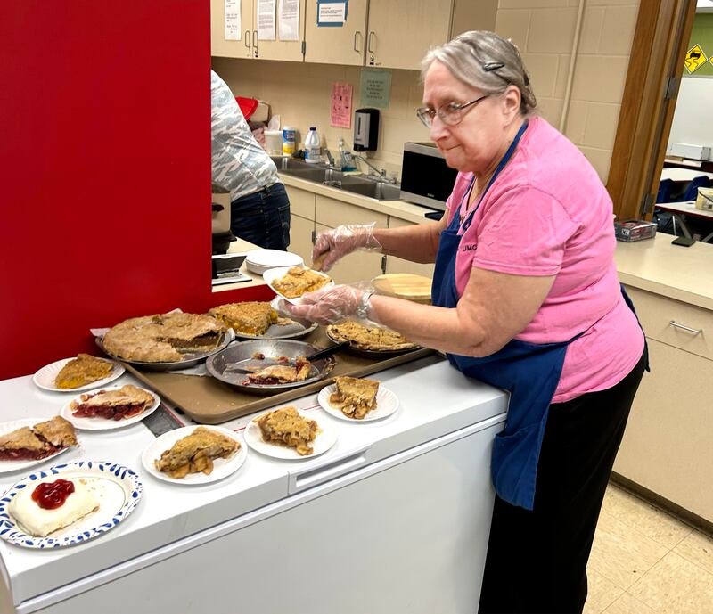 Gail Beck serves up slices of homemade pie at the Chana United Methodist Ladies' concession stand during the Oregon Woman's Club Antique Show & Vintage Market held at the Blackhawk Center in Oregon on Sunday, March 23, 2025.