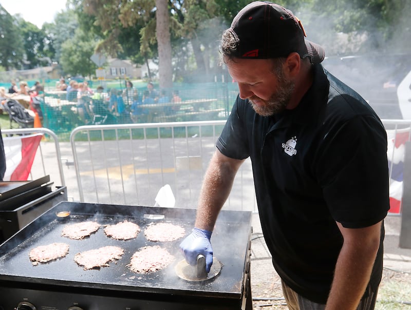 Kevin Byrnes, of Smash’D, cooks a smashed burger during Lakeside Festival on Friday, July 5, 2024, at the Dole.