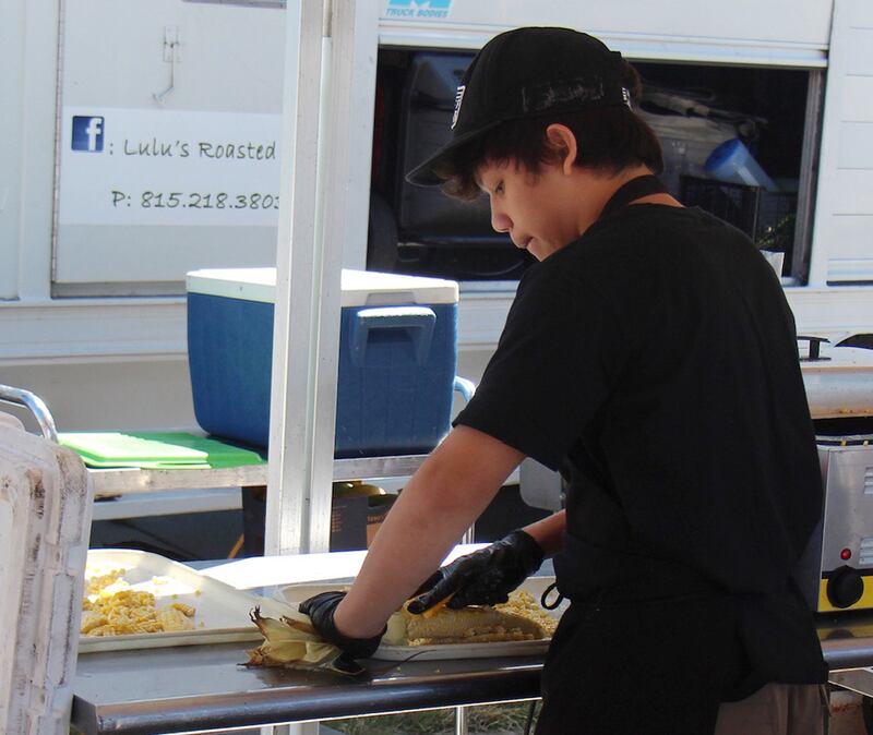 Christian David Contreras Jane, 14, works in the Lulus Roasted Corn Tent on Saturday, Sept. 7, 2024, at Taste of Fiesta in Rock Falls.