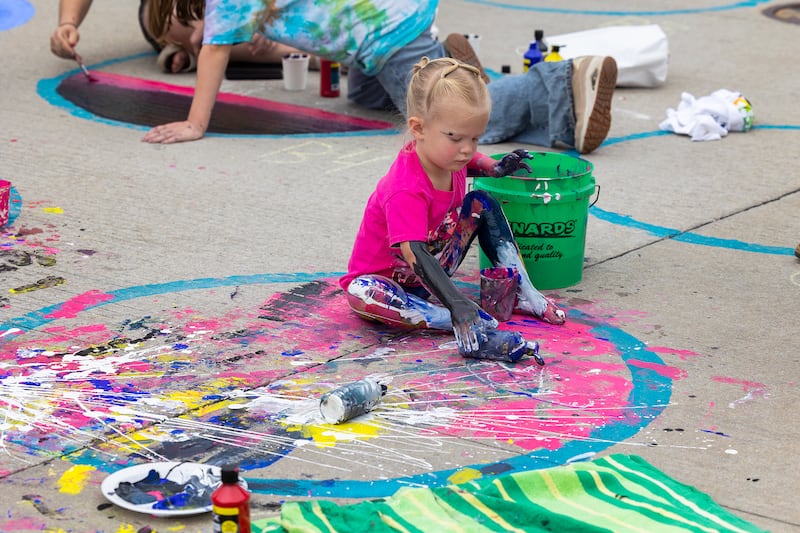 Channeling her inner Jackson Pollock, expressionist painter Kinsley Huizenga, 2, gets into her work during Morrison’s Paint the Town Saturday, Sept. 20, 2025.