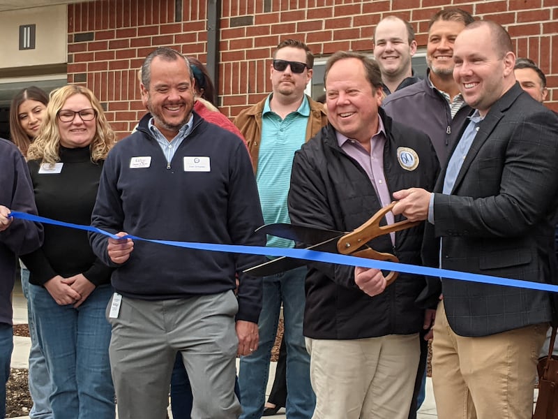 Shodeen Group President Dave Patzelt, left, and Oswego Village President Ryan Kauffman, right, cut a ribbon to celebrate the opening of The Reserve at Hudson Crossing North in downtown Oswego on April 10, 2026.